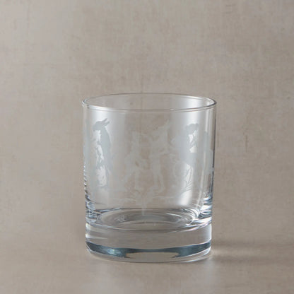 Shakespeare whisky glass with engraved Midsummer Nights Dream design on a beige background