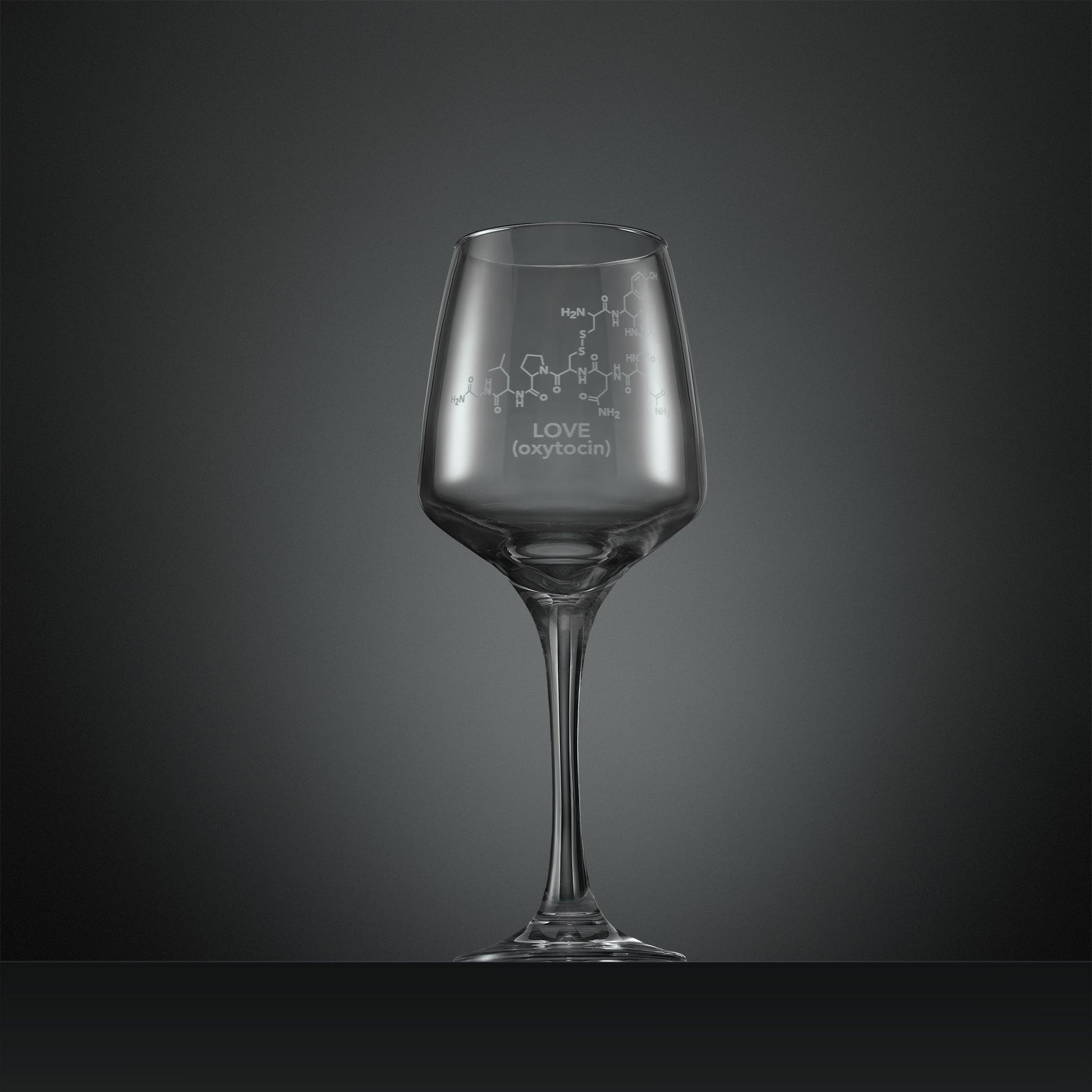 Engraved wine glass with molecular design and 'LOVE (oxytocin)' text