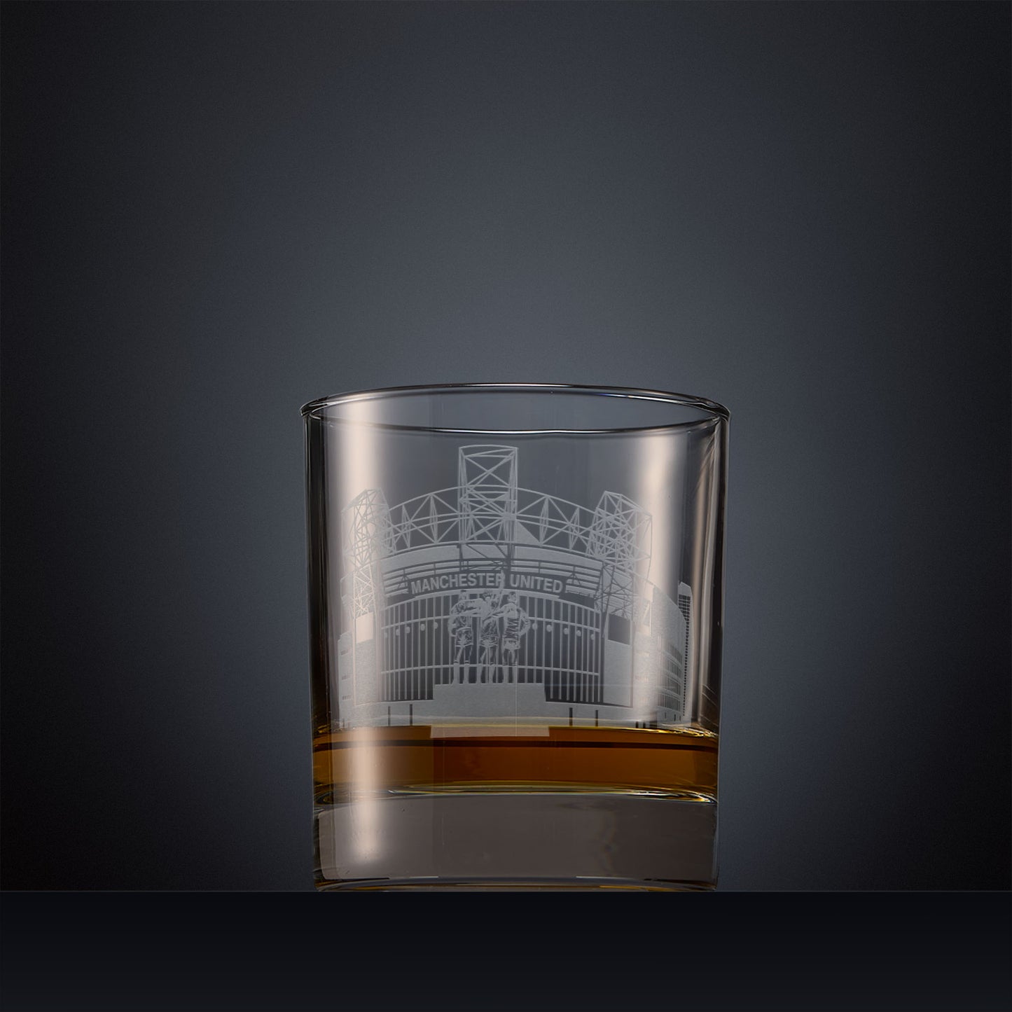 Engraved whisky glass with Old Trafford, Manchester's football stadium on a black background