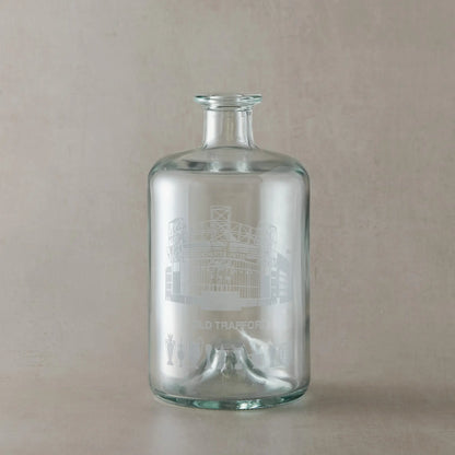 Engraved decanter featuring a line-art interpretation of Old Trafford with trophy silhouettes beneath.
