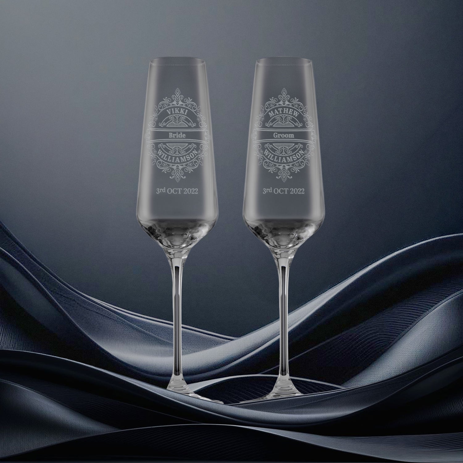 Pair of wedding champagne flutes engraved with a lacework design and personalised with the bride and grooms names