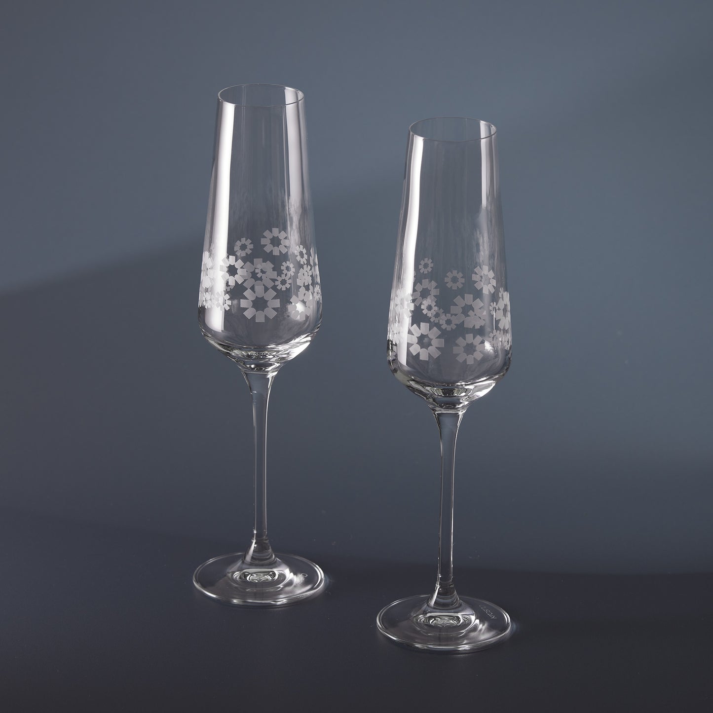 Engraved clear champagne flutes with 360 degree floral patterns