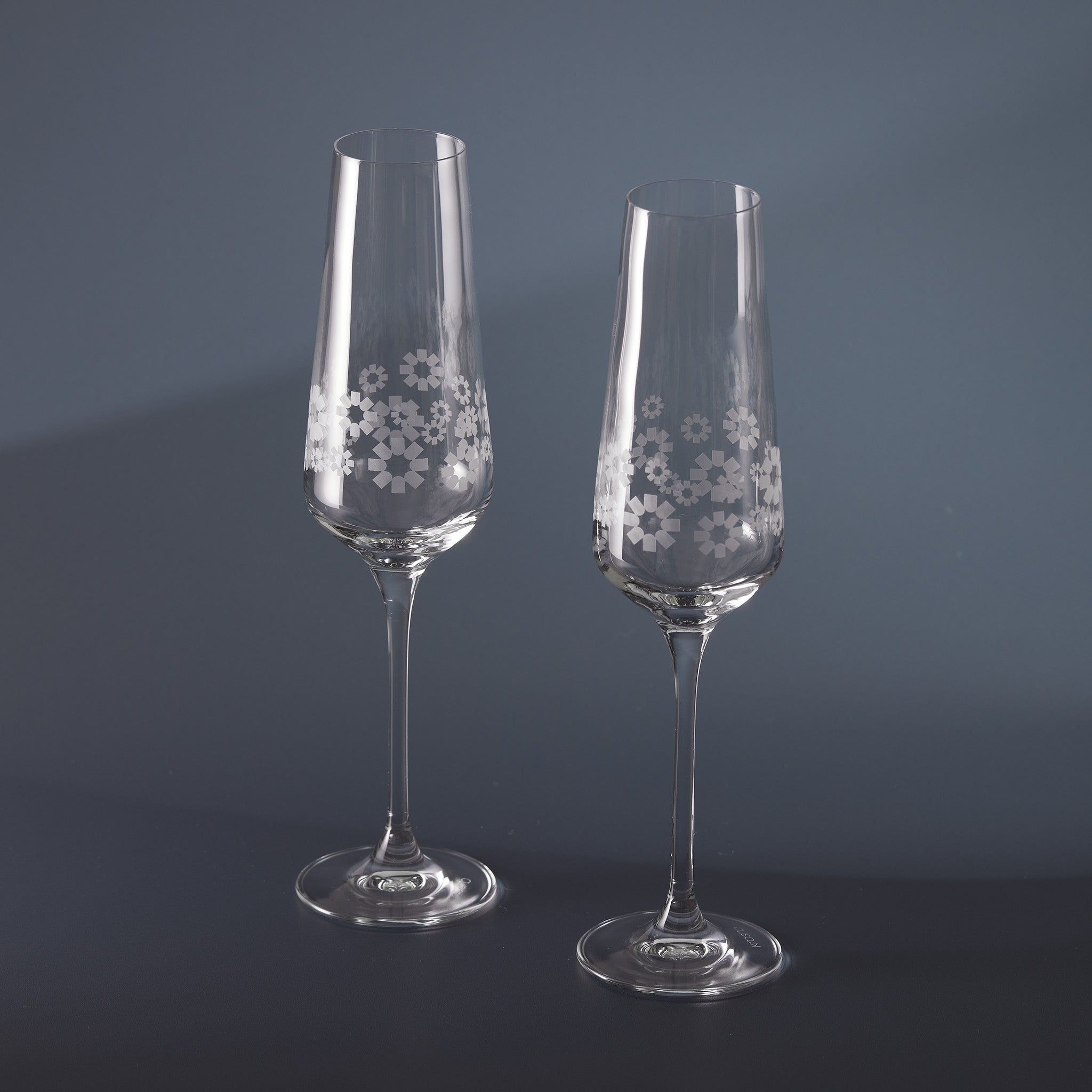 Engraved clear champagne flutes with 360 degree floral patterns