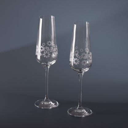 Engraved clear champagne flutes with 360 degree floral patterns