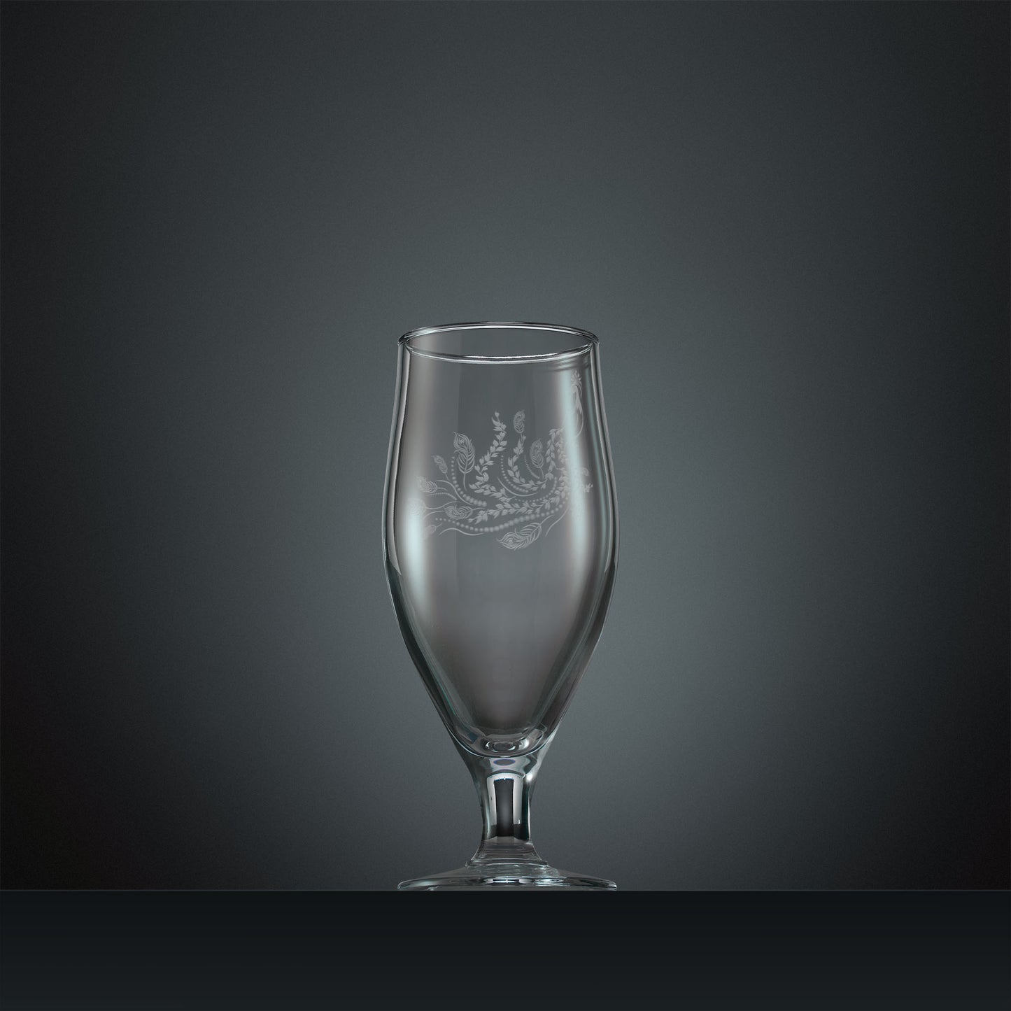 Engraved stemmed beer glass with a peacock, trailing leaves and feathers design