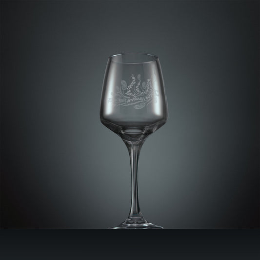 Engraved wine glass with a peacock, trailing leaves and feathers design