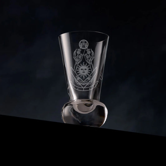 Masonic firing glass engraved with thistles and square and compass design of the right worshipful master on a dark background