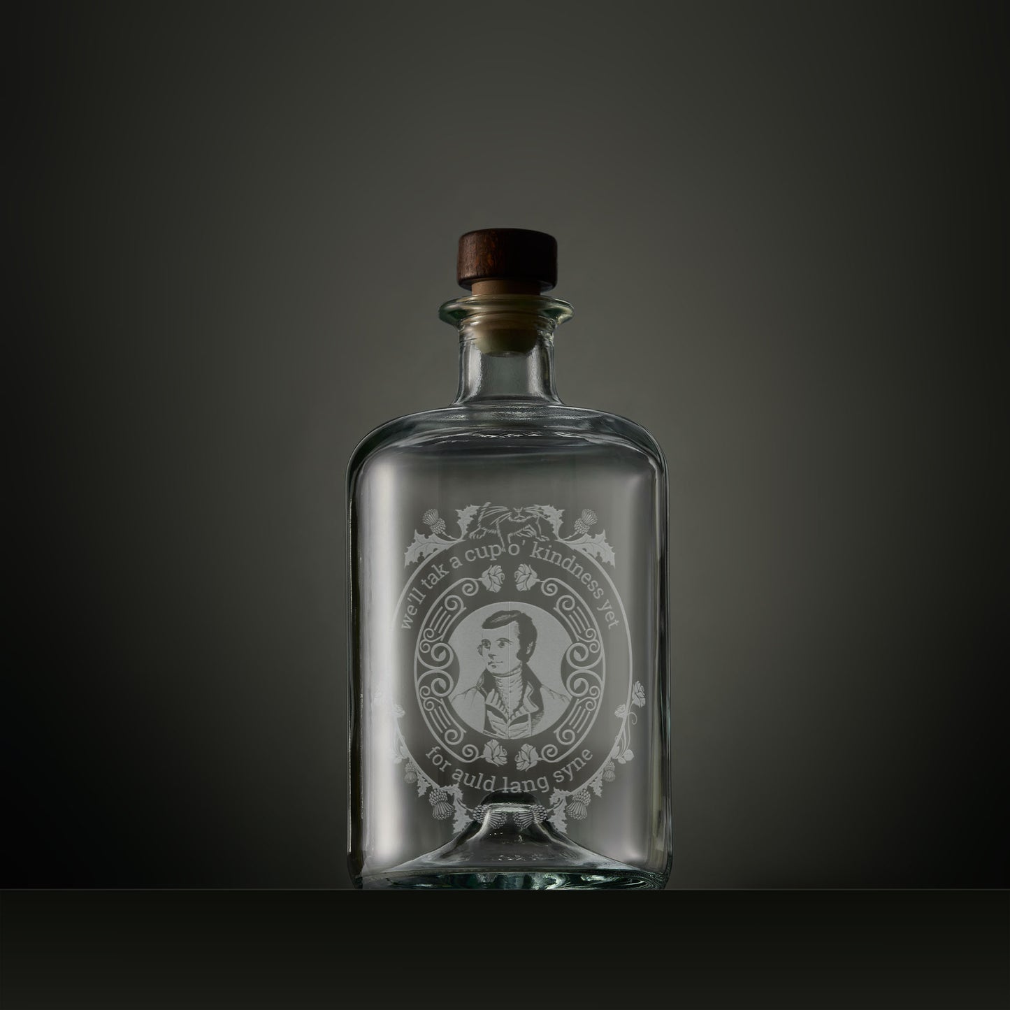 Engraved apothecary-style decanter with engraved portrait of Robert Burns surrounded by thistles