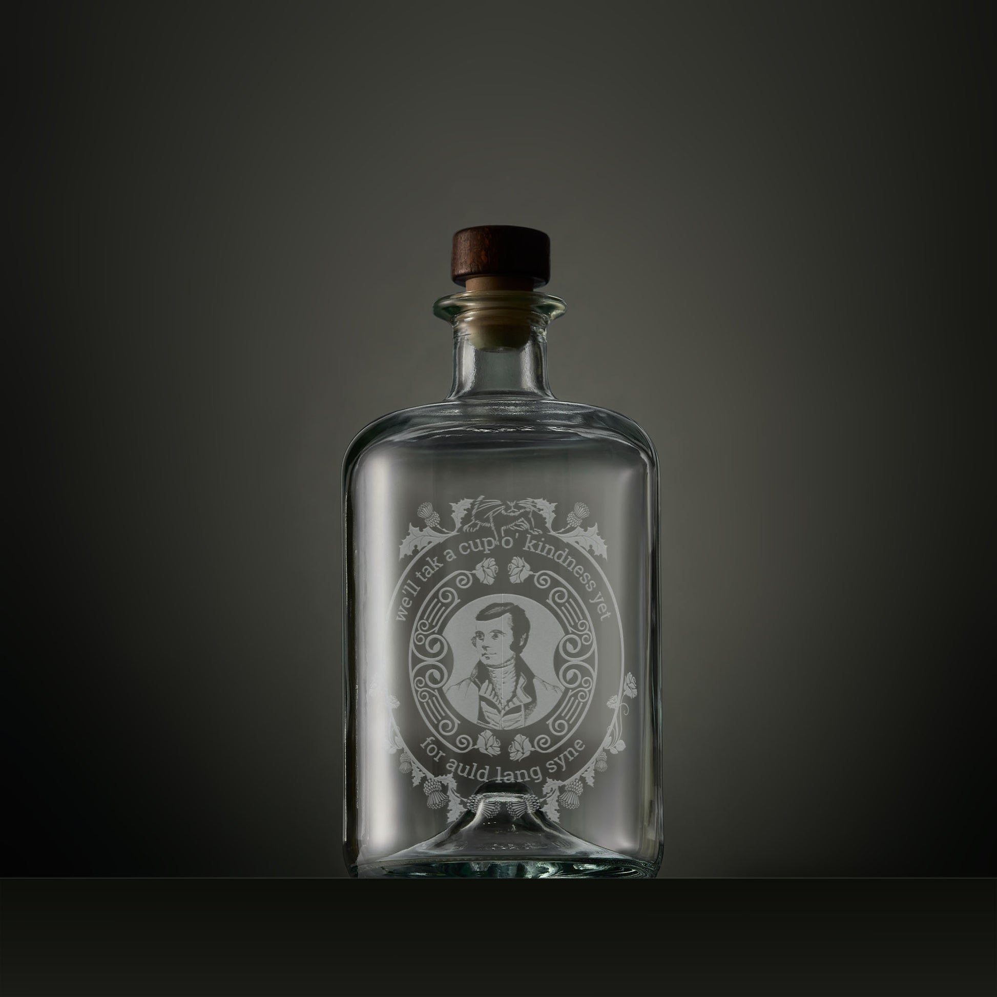 Engraved apothecary-style decanter with engraved portrait of Robert Burns surrounded by thistles