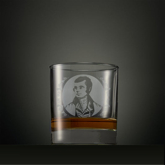 Engraved whisky glass with a portrait of Robert Burns surrounded by thistles