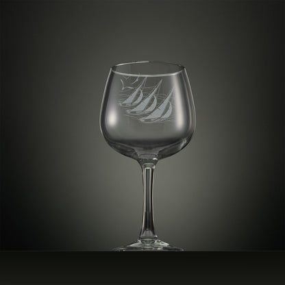 Engraved gin glass with three sailing yachts and seabirds overhead 