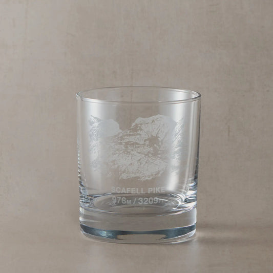 Whisky glass engraved with Scafell Pike, photographed on a neutral coloured background
