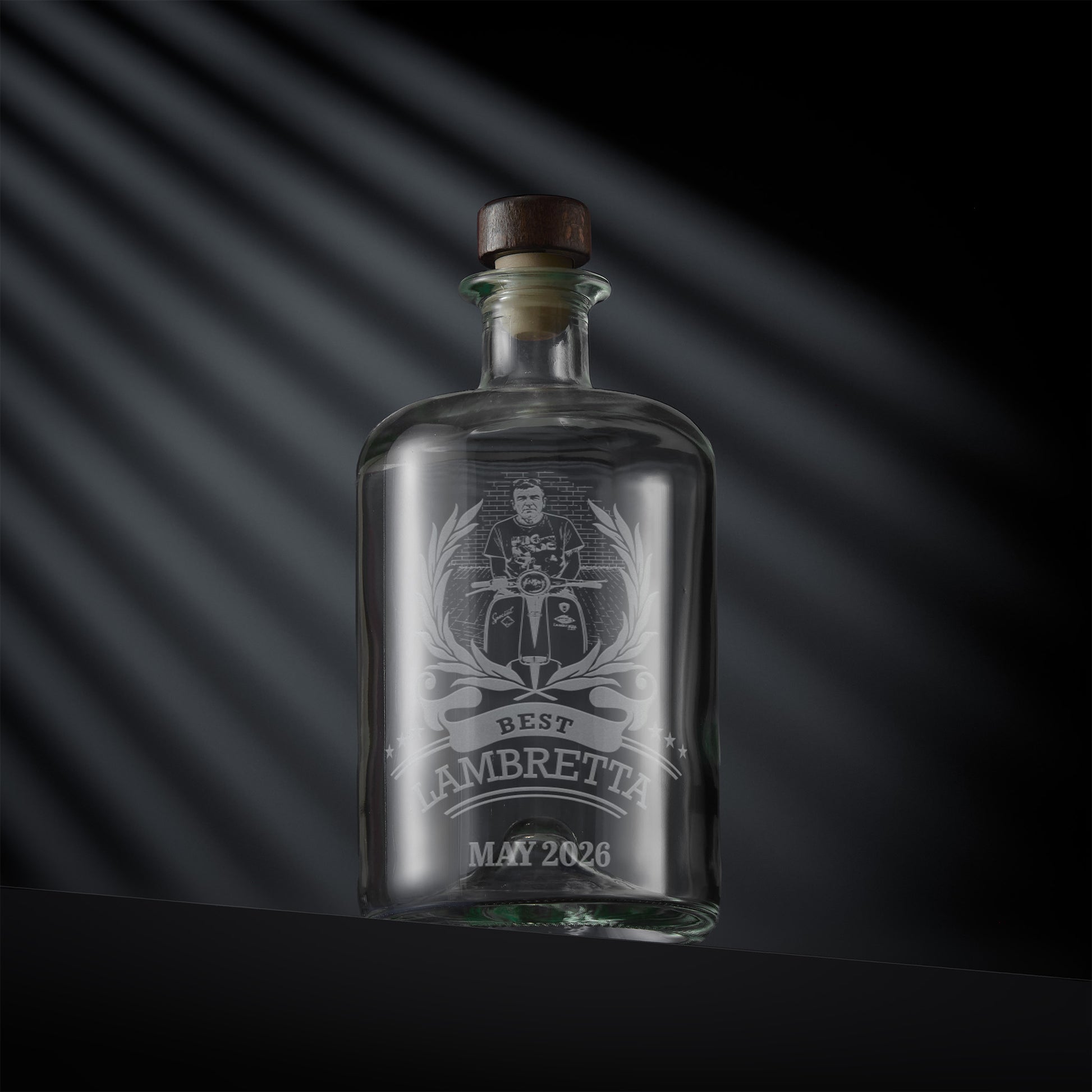Glass bottle with engraved scooter rally design and inscription