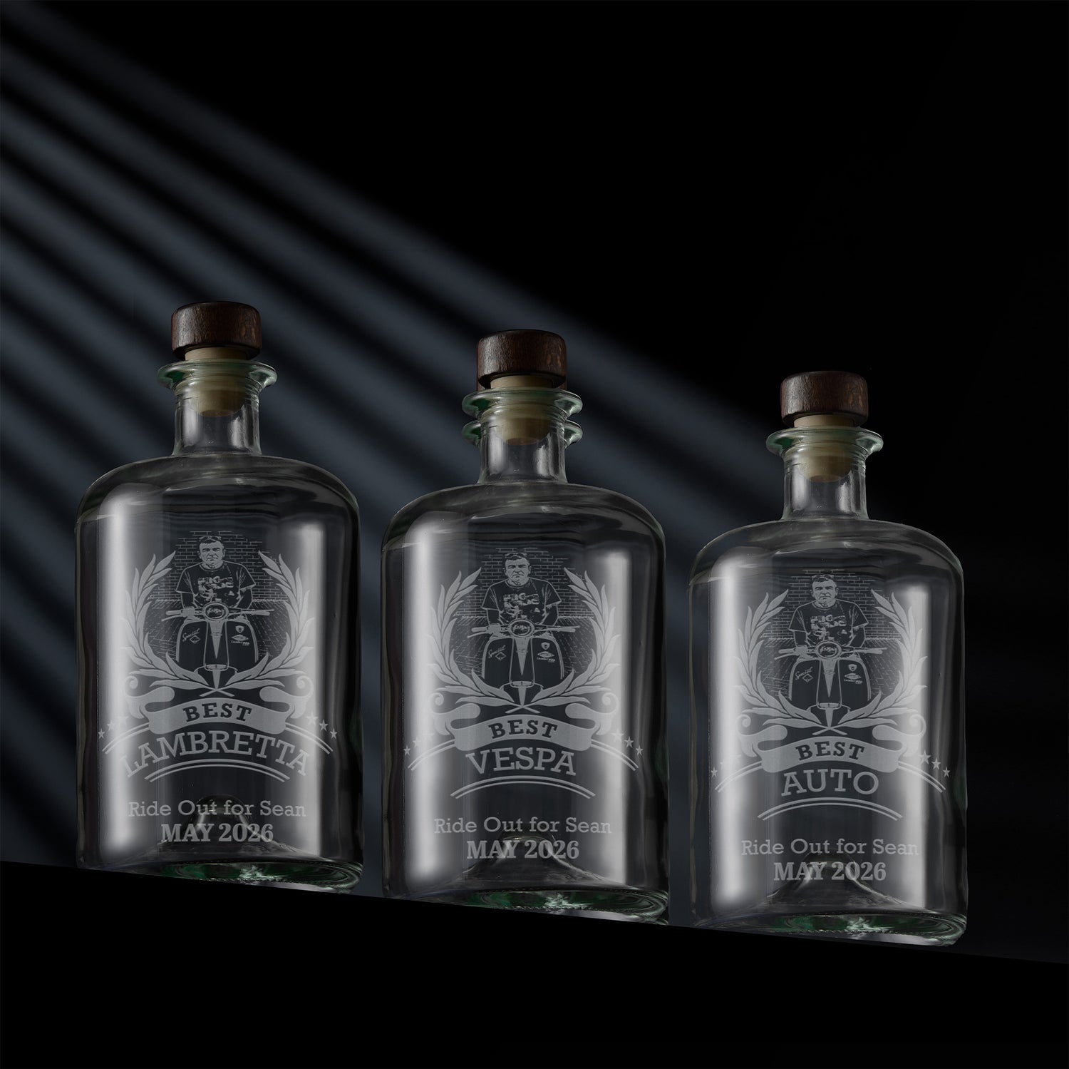 Three engraved apothecary style decanters with a Scooter Rally award design and personalised text