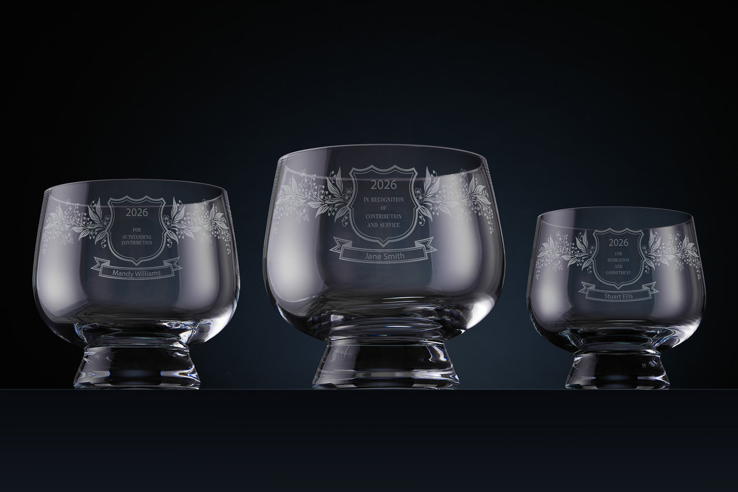 Three engraved glass rose bowls with personalised commemorative text, names and dates