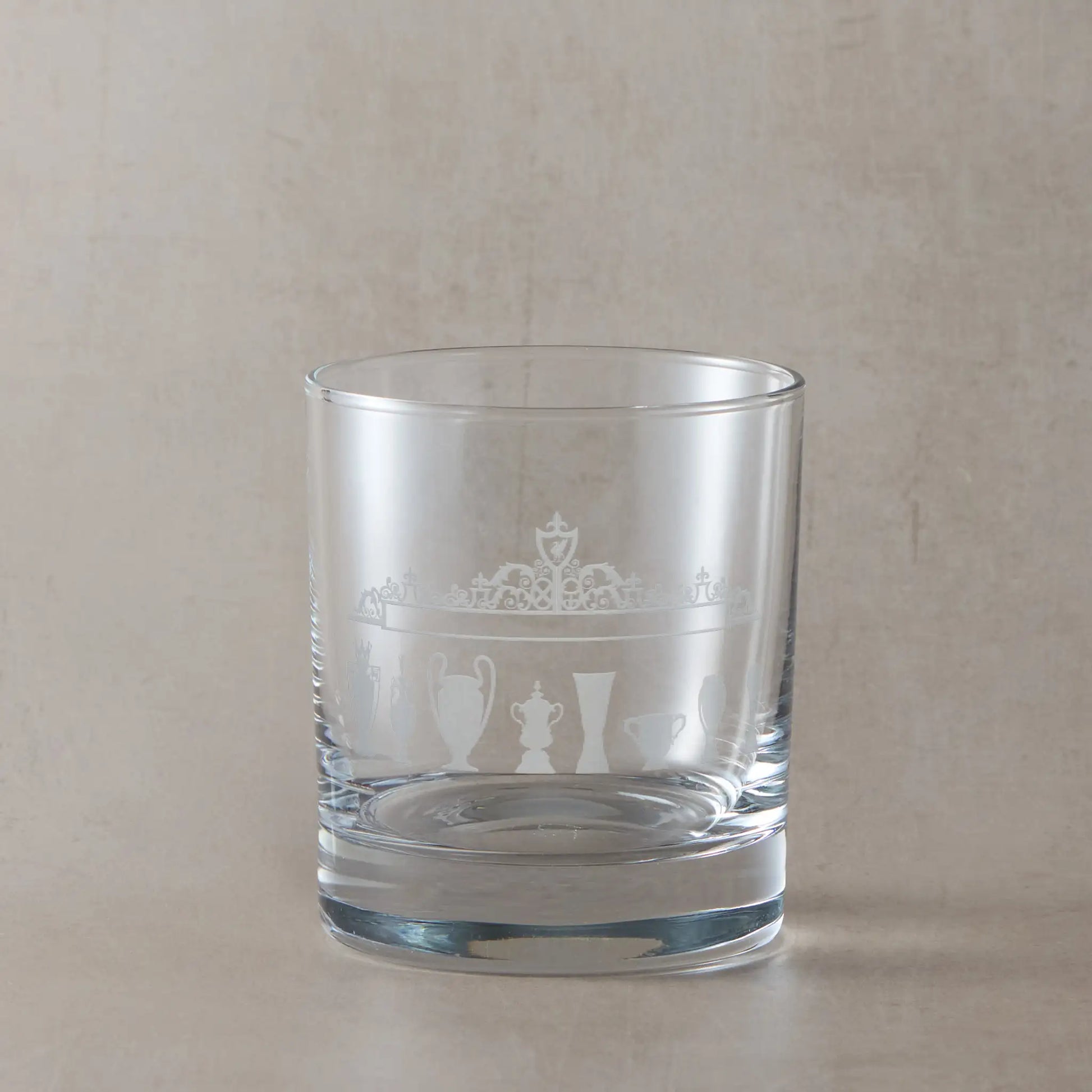 Engraved whisky glass featuring football trophy silhouettes and Shankly Gates outside of Liverpool's Anfield stadium