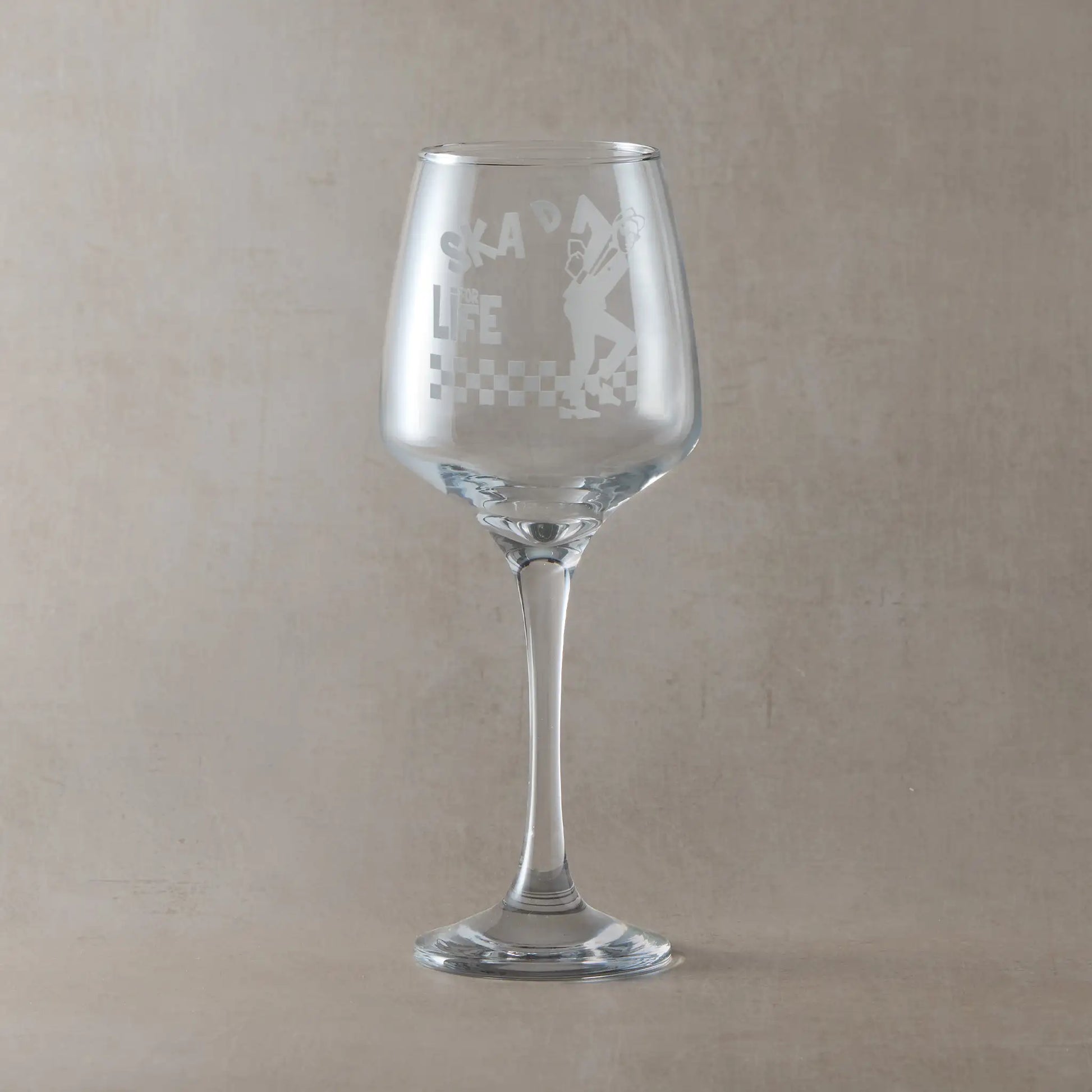 Wine glass with Walt Jabsco engraving and SKA'd for Life text, on a pale background
