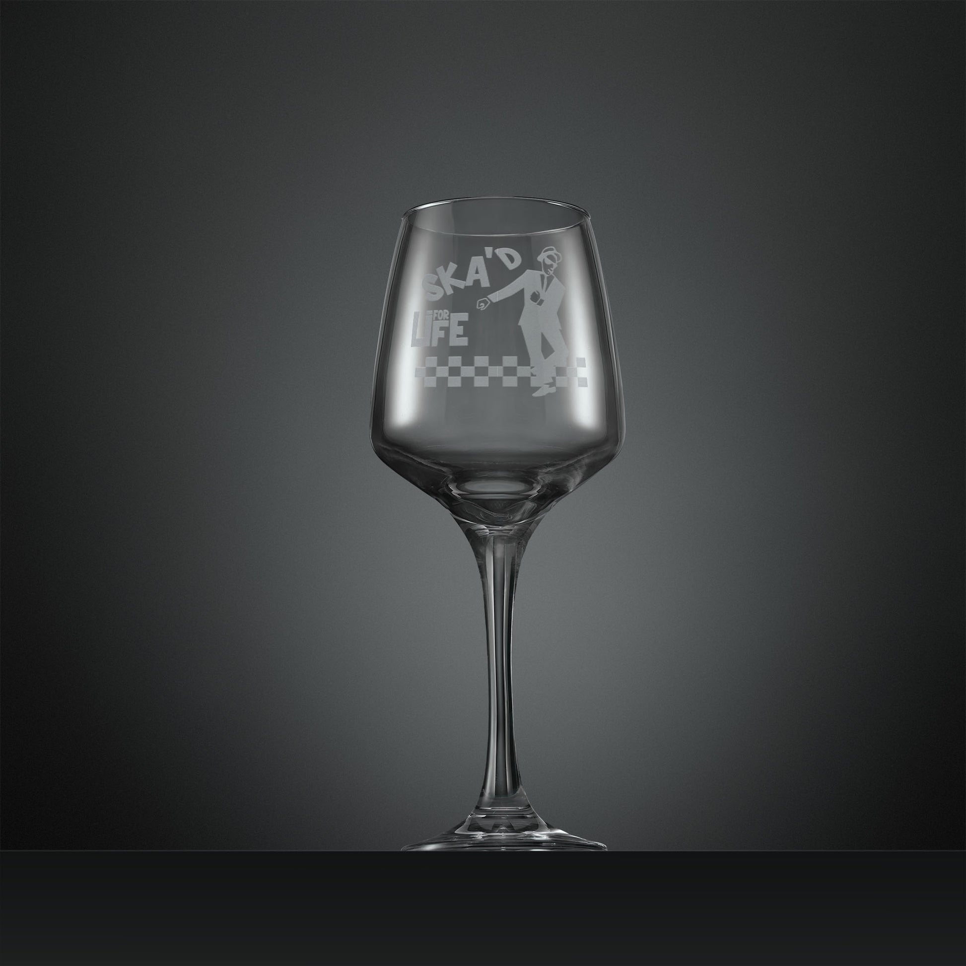 Engraved wine glass featuring a dancing SKA man on a checkerboard floor with inscription