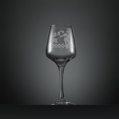 Engraved wine glass featuring a dancing SKA man on a checkerboard floor with inscription