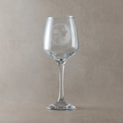 Wine glass engraved with a rude girl dancing, surrounded by a checkerboard design and the word "Ska"