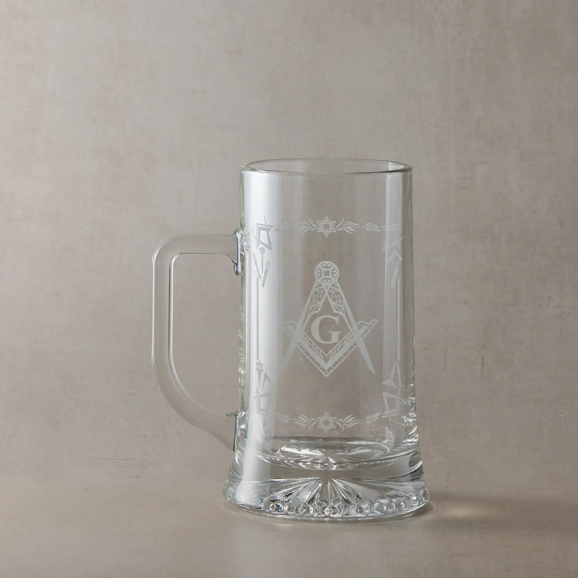 Masonic  tankard with Square & Compass and working tools design, displayed on beige background, handle to the left of design