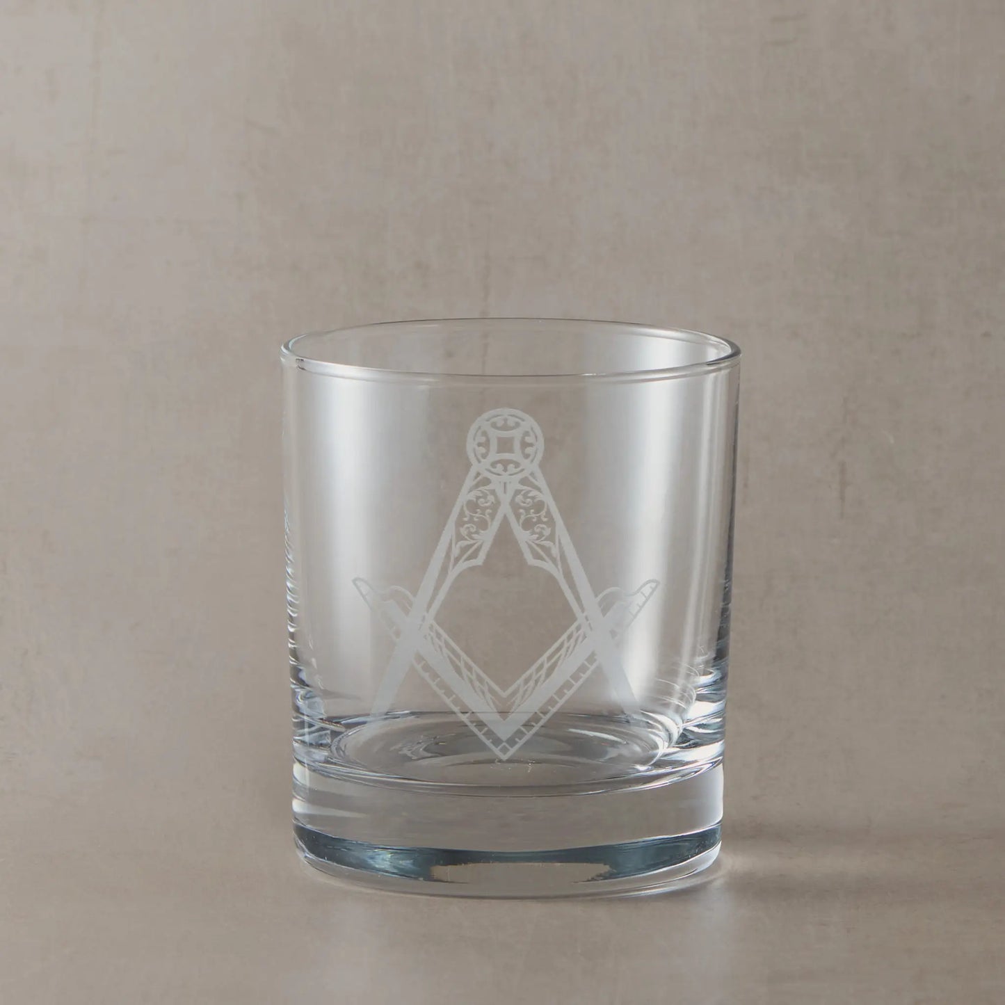 Whisky glass engraved with a detailed masonic square and compass