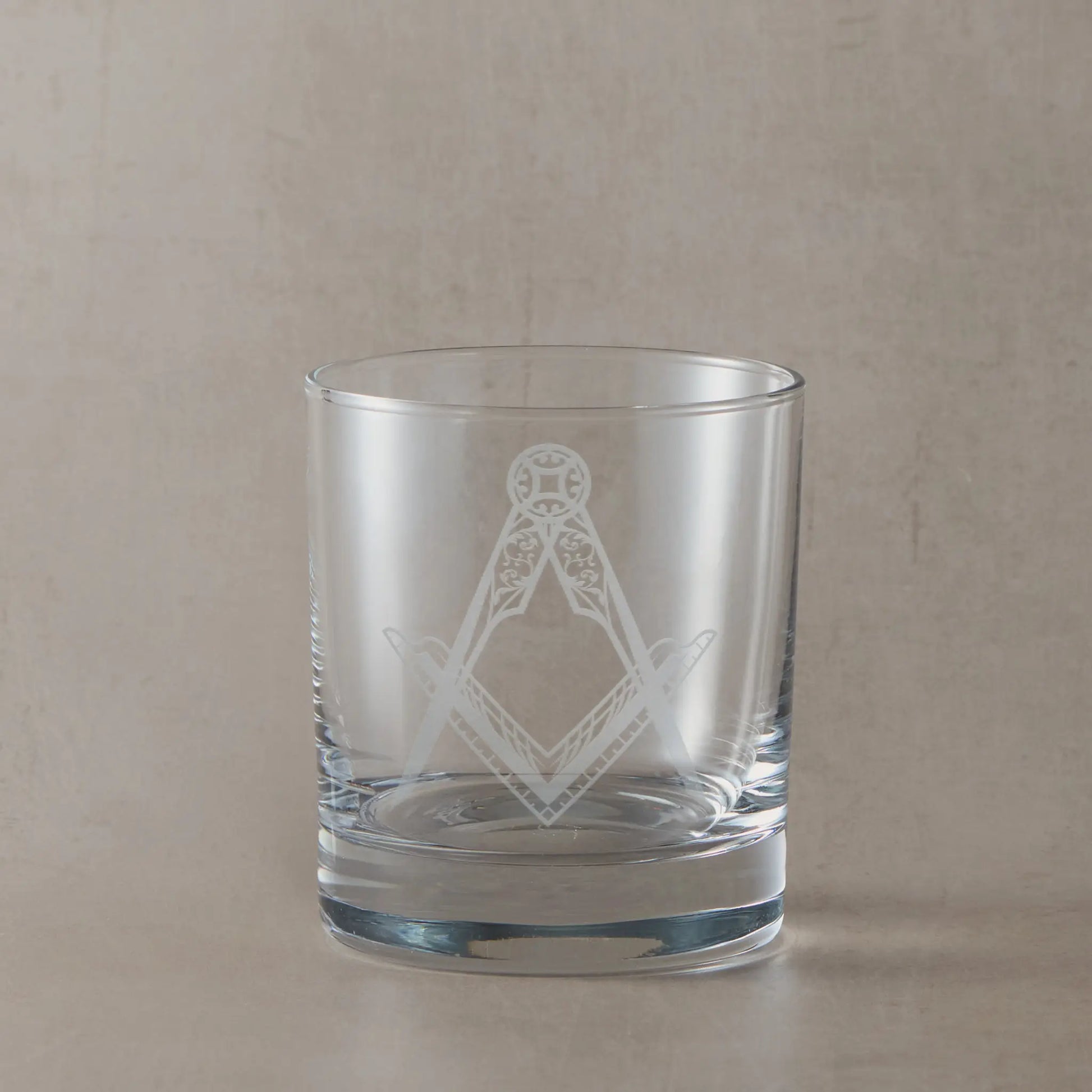 Whisky glass engraved with a detailed masonic square and compass