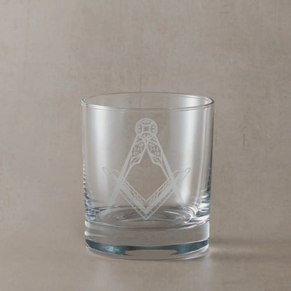 Whisky glass engraved with a detailed masonic square and compass