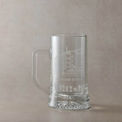 Clear glass tankard engraved with Stamford Bridge stadium in Chelsea, shown against a pale background.