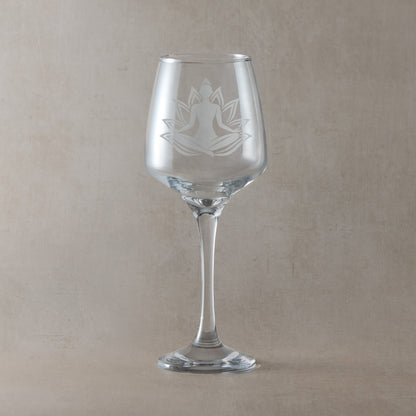 Wine glass engraved with a woman practicing Yoga set against a lotus flower