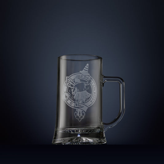 Engraved tankard with dancing Scotsman in a kilt carrying bagpipes and traffic cone surrounded by a clan crest buckle