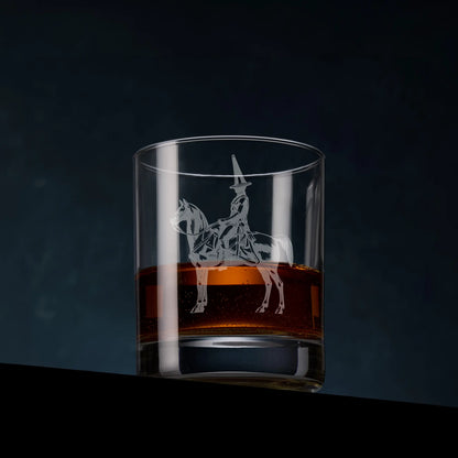 Engraved whisky glass featuring the Duke of Wellington statue in Glasgow, complete with its iconic traffic cone, shown on a dark studio background with a dram of whisky to highlight the engraving