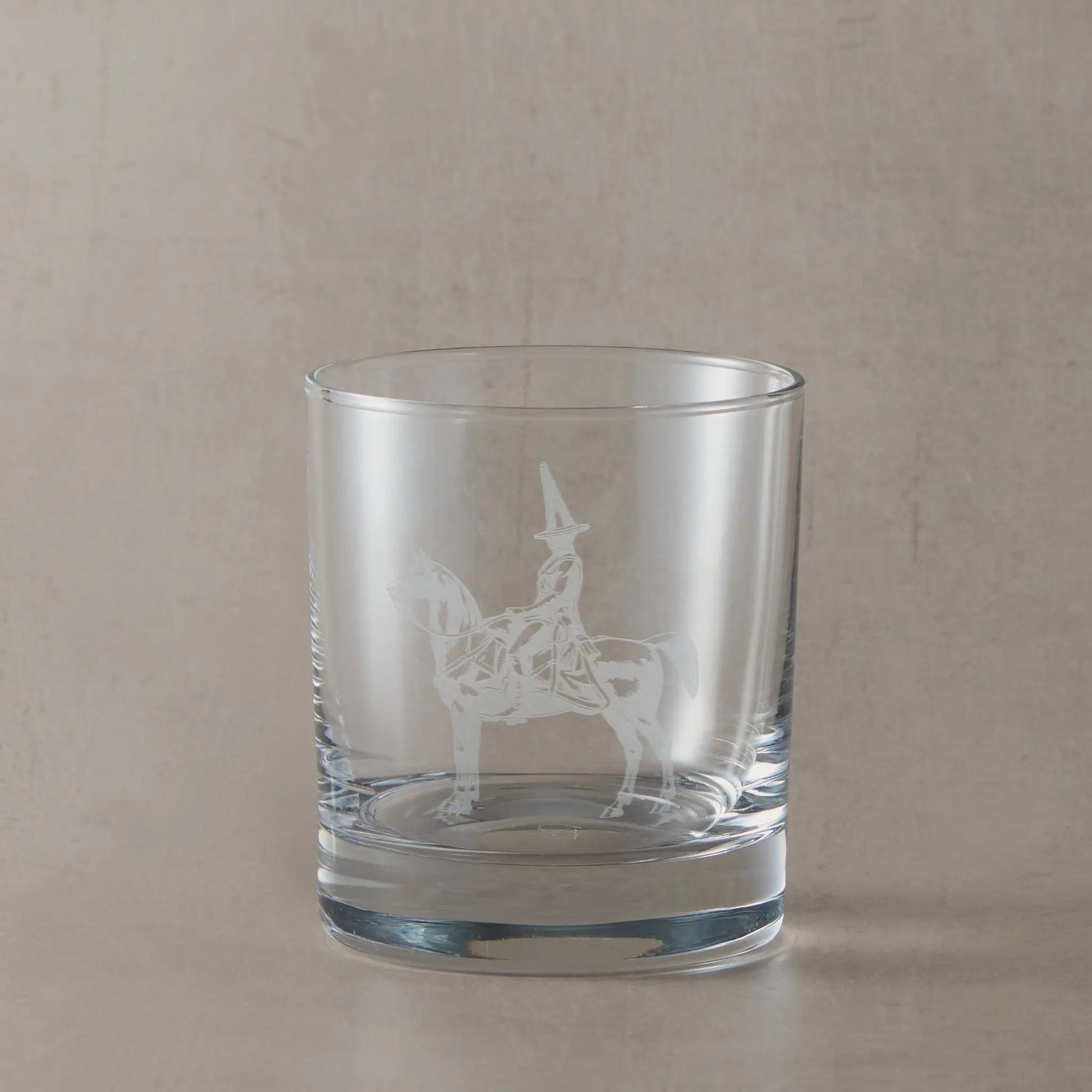 Engraved whisky glass featuring the Duke of Wellington statue in Glasgow with its iconic traffic cone, shown on a neutral studio background