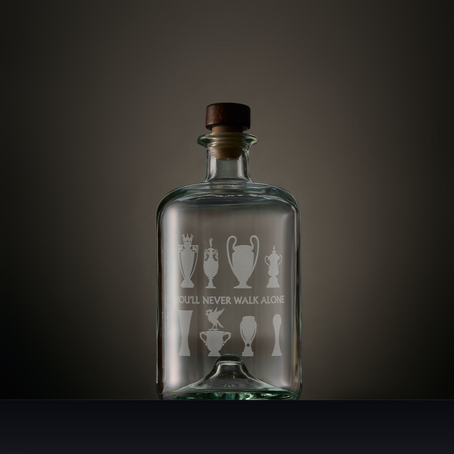 Engraved apothecary style decanter featuring Liverbird and trophy silhouettes with personalised inscription on a dark background