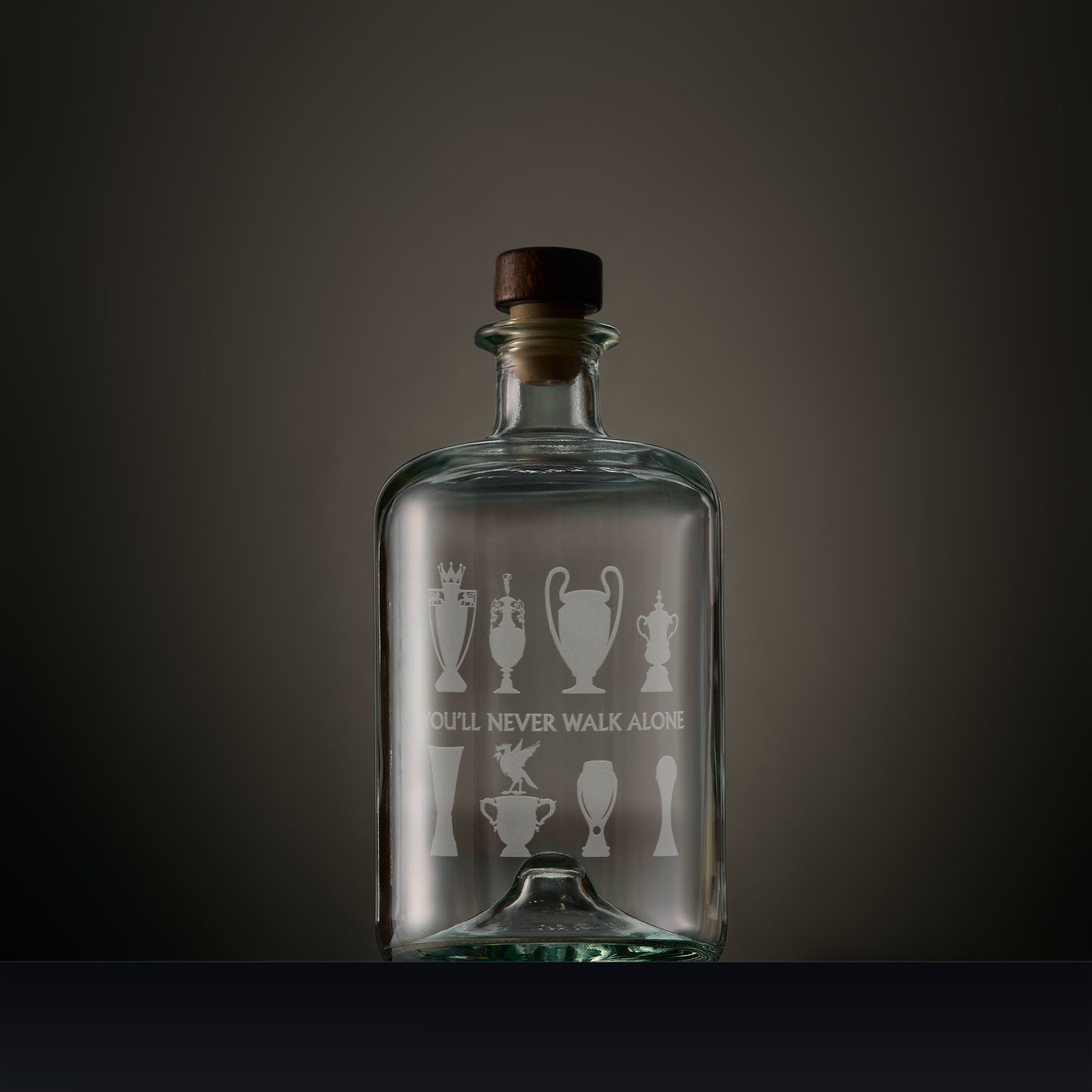 Engraved apothecary style decanter featuring Liverbird and trophy silhouettes with personalised inscription on a dark background