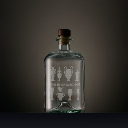 Engraved apothecary style decanter featuring Liverbird and trophy silhouettes with personalised inscription on a dark background