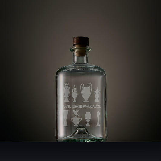 Engraved apothecary style decanter featuring Liverbird and trophy silhouettes with personalised inscription on a dark background