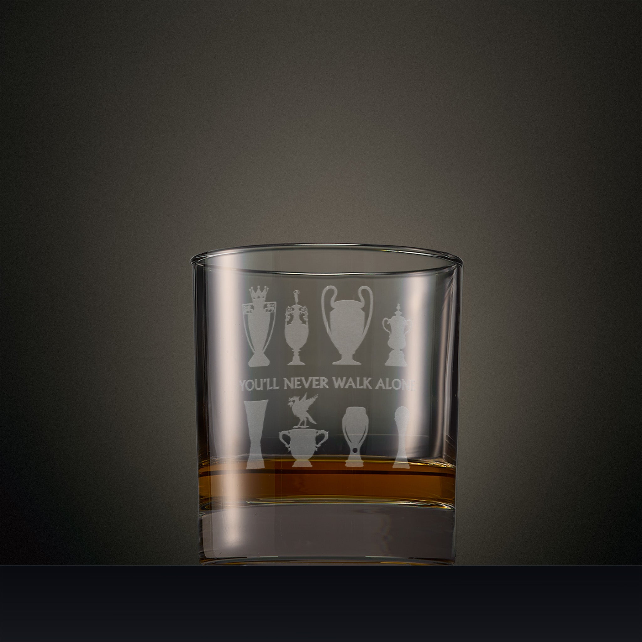 Engraved whisky glass featuring a Liverbird on a trophy, with seven other trophy silhouettes