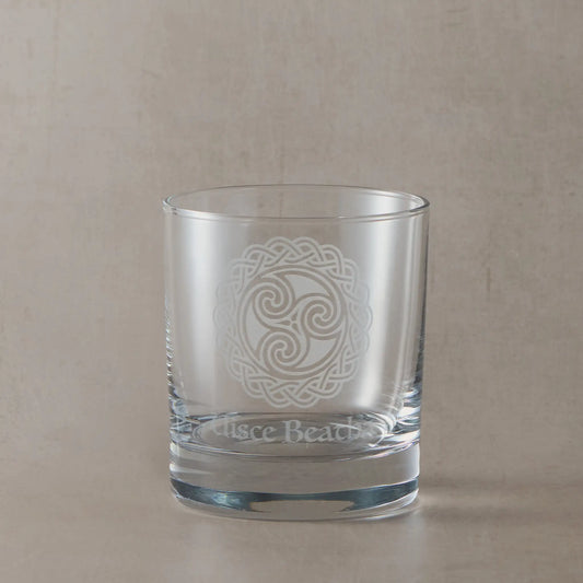 Glass tumbler engraved with Uisce beatha, the Irish Gaelic name for Irish whiskey and celtic knotwork