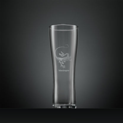 Engraved pint glass with velociraptor fossil design