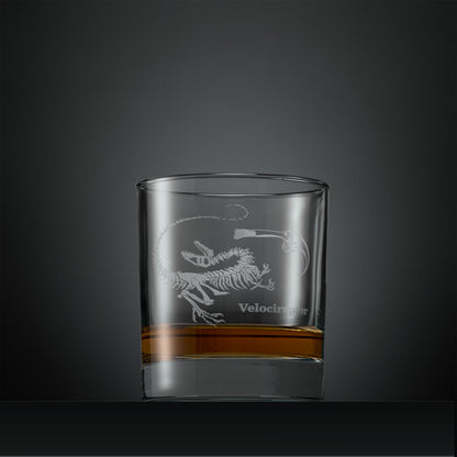 Engraved whisky glass with velociraptor fossil design