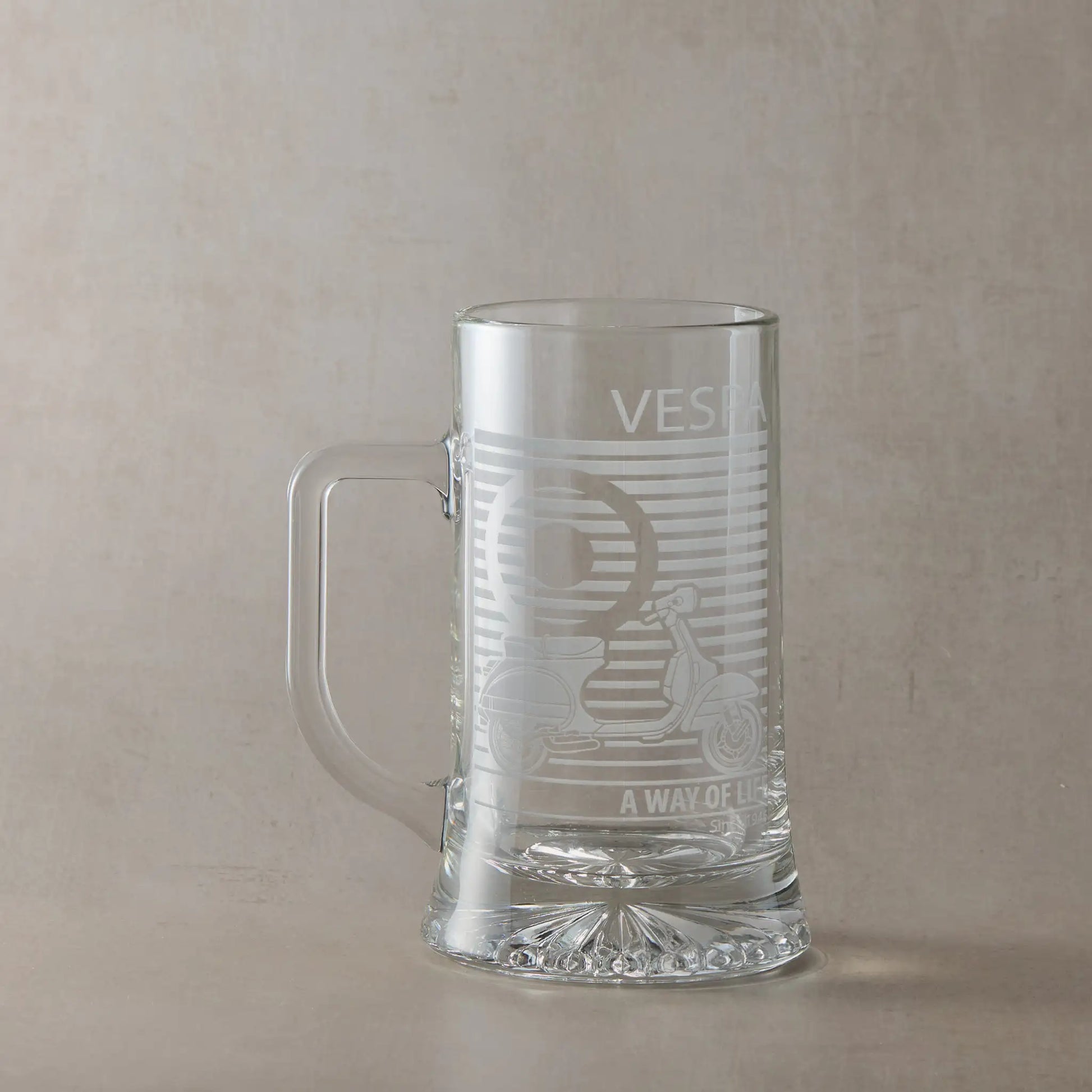 Vespa PX engraved tankard with handle on left, photographed on neutral beige background.