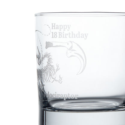 Close-up engraving detail of a Velociraptor dinosaur fossil etched on a whisky glass