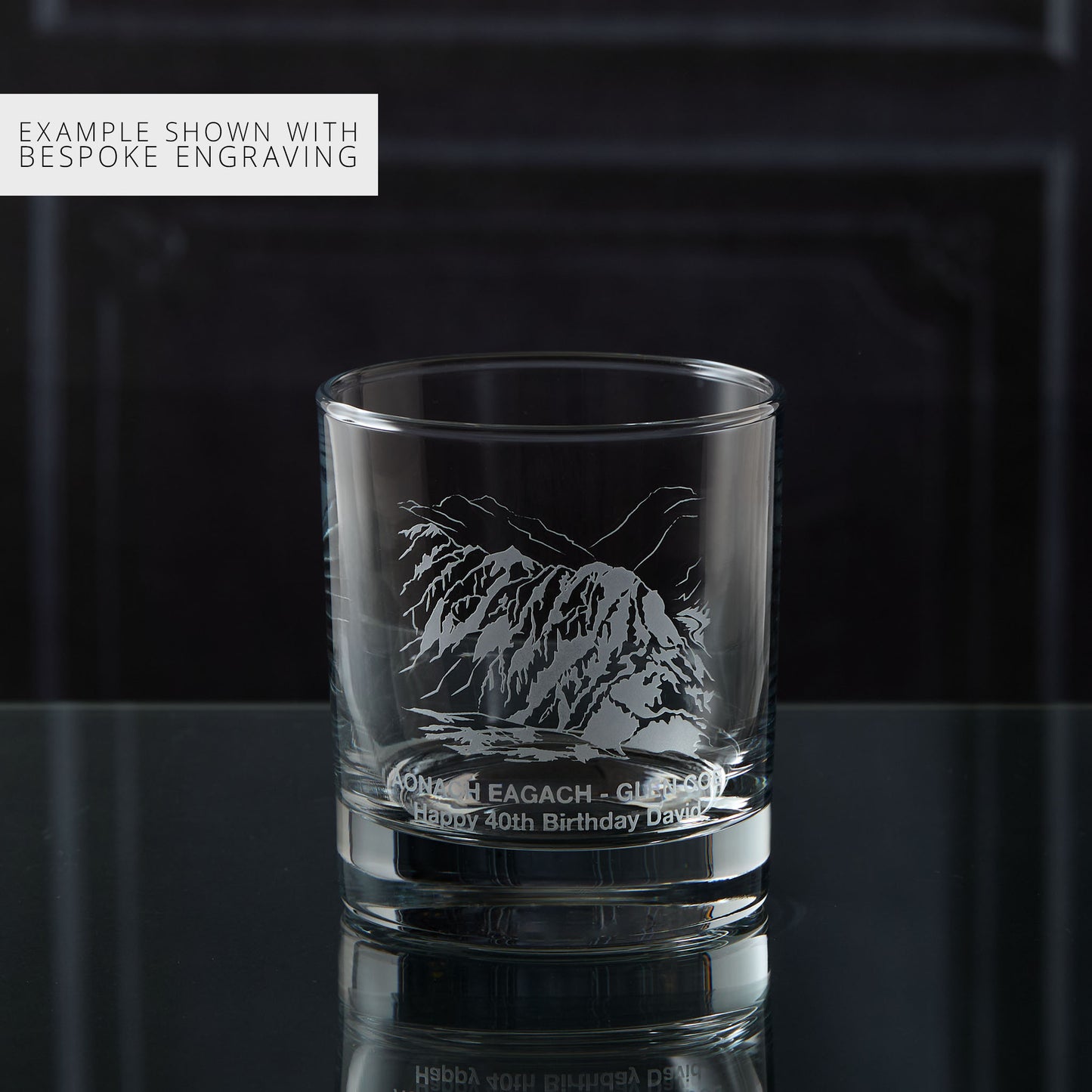 Personalised whisky glass engraved with the Aonach Eagach ridge, photographed on a black background