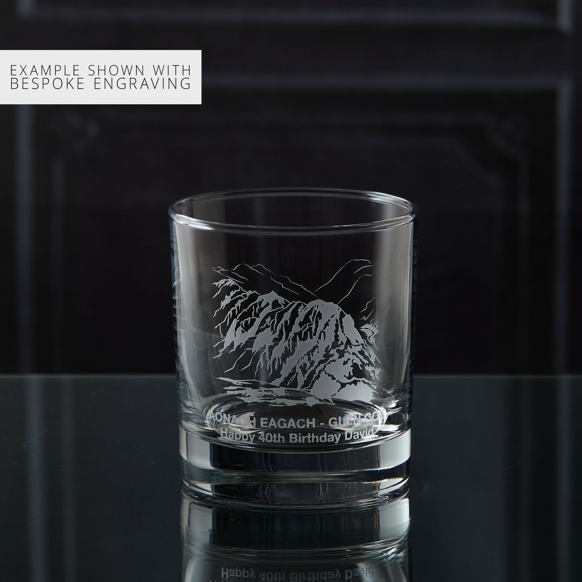 Personalised whisky glass engraved with the Aonach Eagach ridge, photographed on a black background