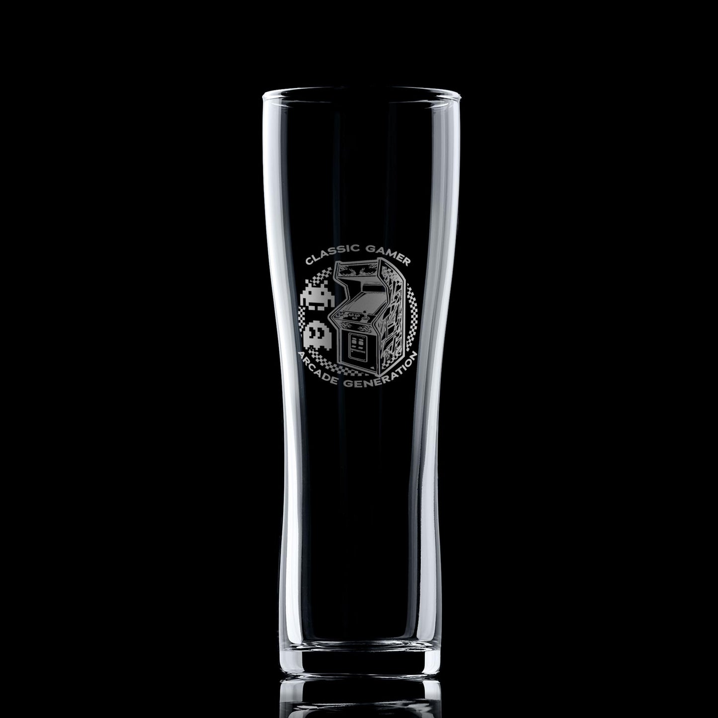 Engraved arcade pint glass with retro cabinet design, photographed on a black background to highlight engraving details.
