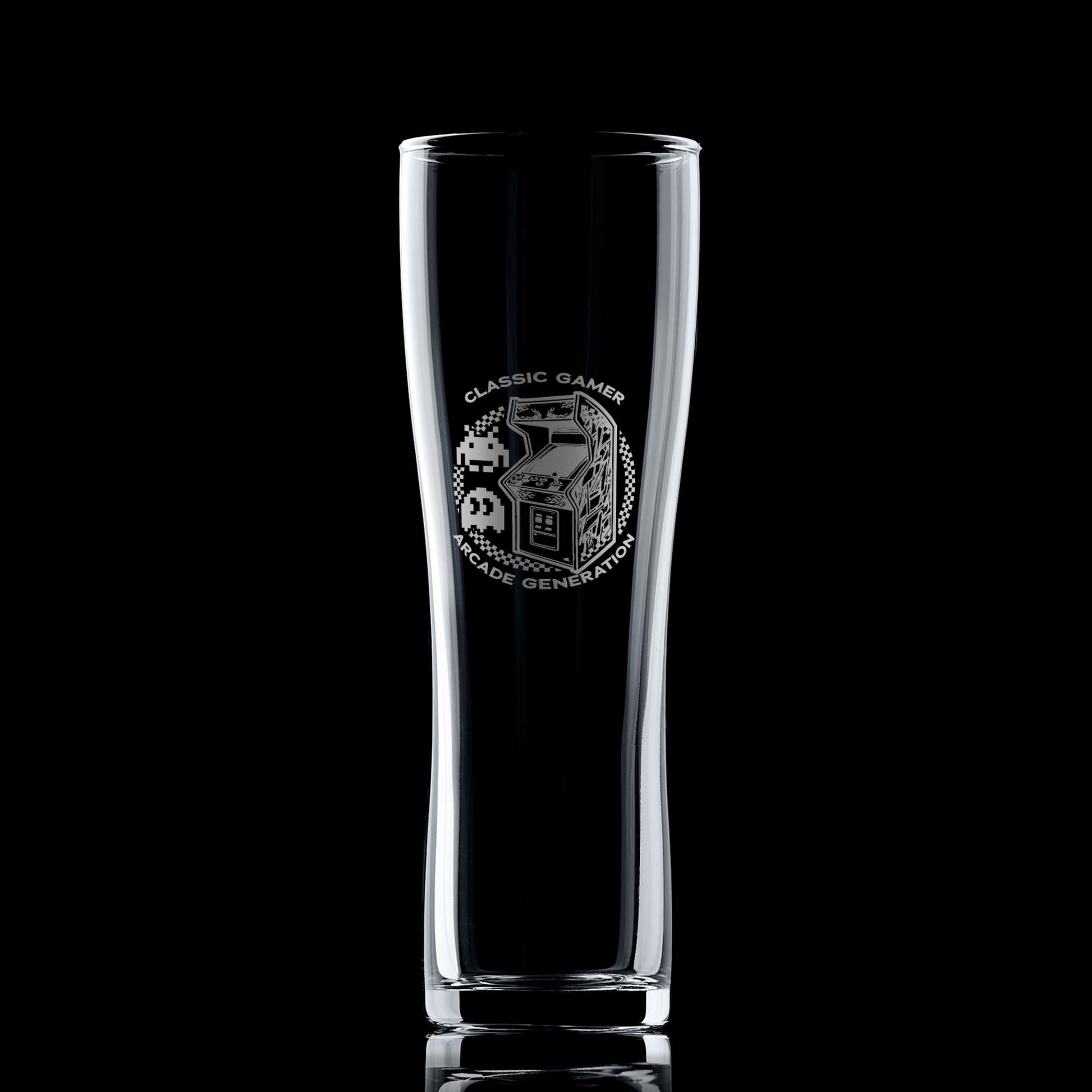 Engraved arcade pint glass with retro cabinet design, photographed on a black background to highlight engraving details.