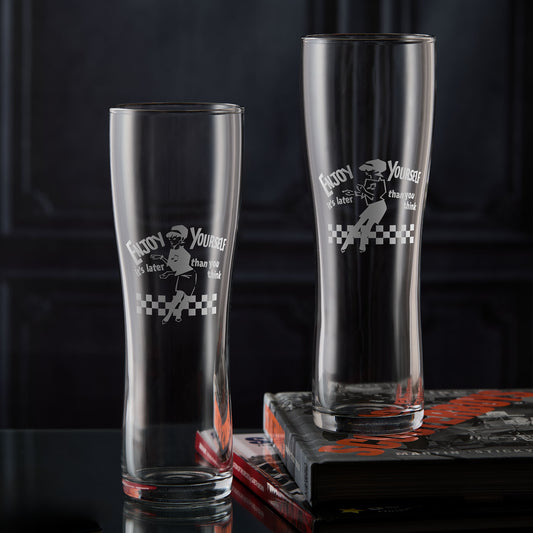 Two Beat Girl pint glasses with 'Enjoy Yourself' text and checkered design on a dark background