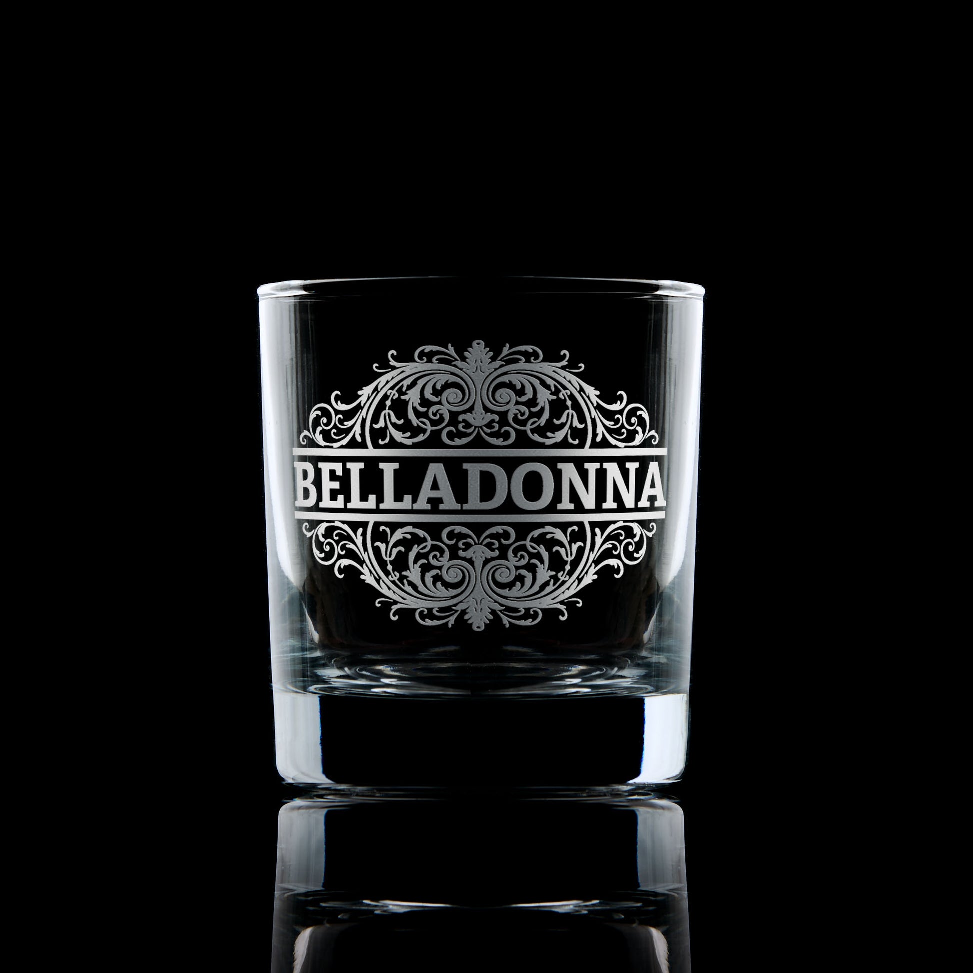 Belladonna engraved whisky glass photographed on a dark background
