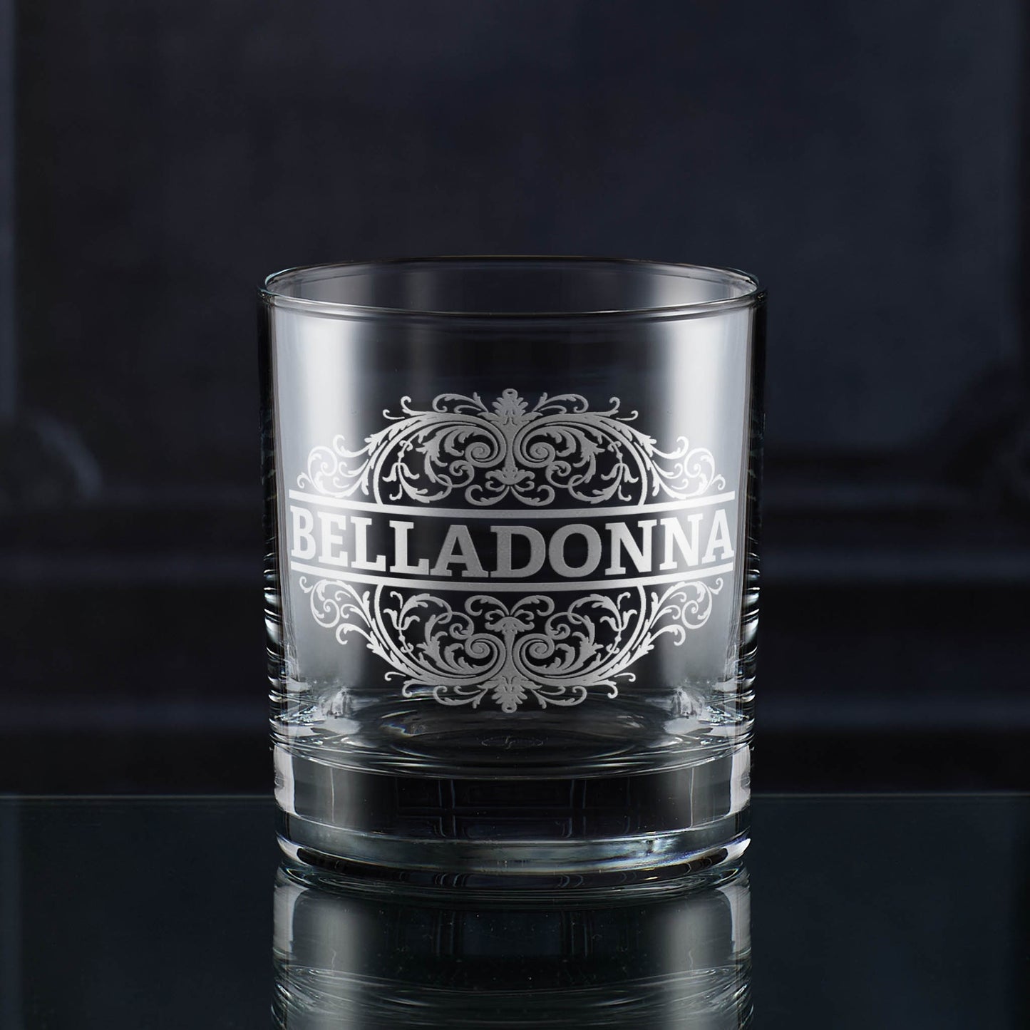 Whisky tumbler engraved with an ornate Belladonna poison label design.